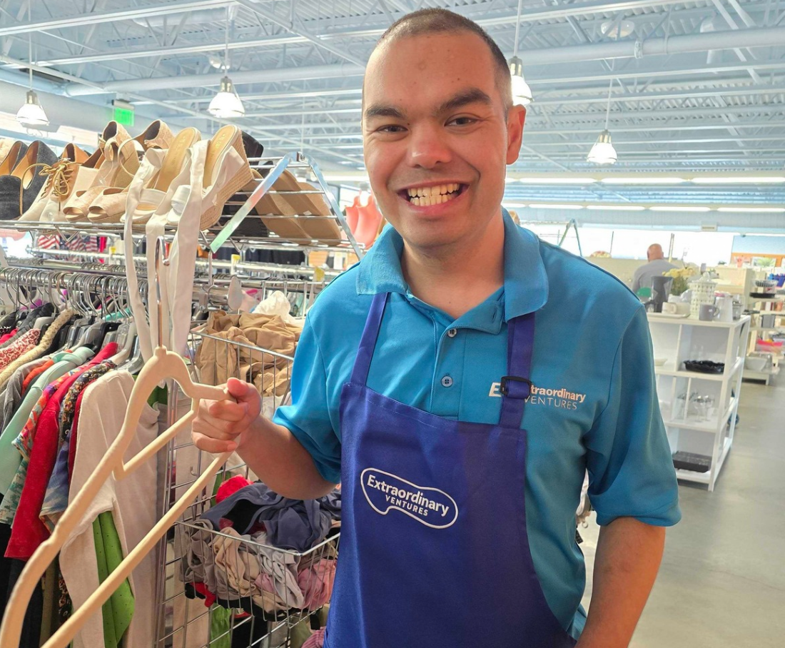 Thrift store employee with hanger